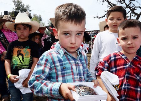 Lions Club Rodeo visitor Case Yecny shows off belt buckle after winning mutton busting contest.